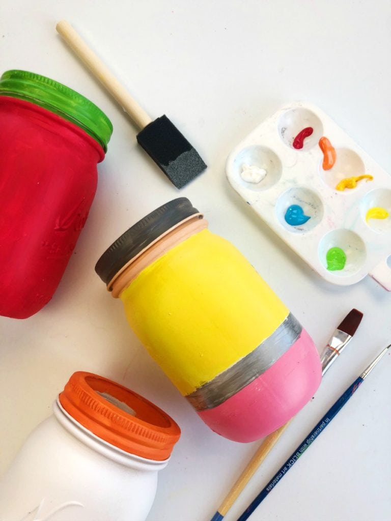 Painted mason jars to look like school supplies - different sized brushes are pictured